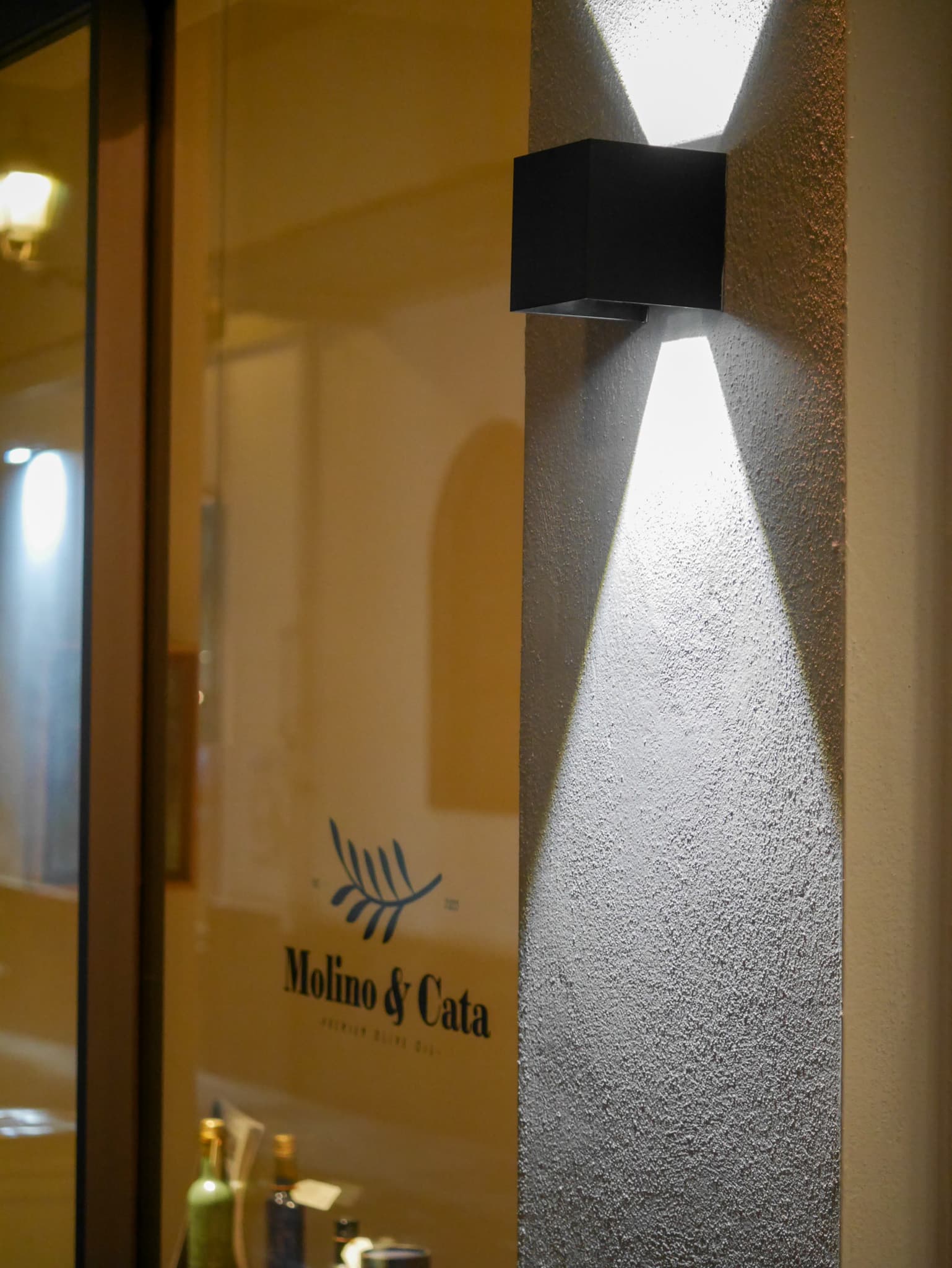 Fachada de la oleoteca Molino & Cata de noche, Calle Paz 12, centro histórico de Granada
